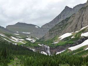 Closeup of Morning Eagle Falls with Piegan Mountain and the Bishops Cap in the background